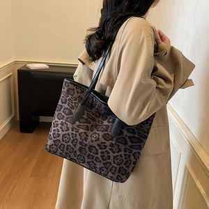 Large leopard print tote bag with black leather handles for stylish daily commuting