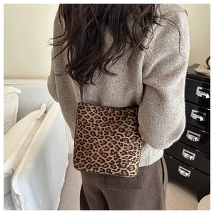 Leopard print tote bag worn with a brown sweater for a stylish casual look