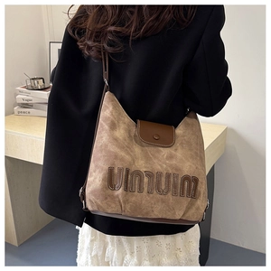 Detailed back view showing the vintage canvas tote bag size and styling on a model