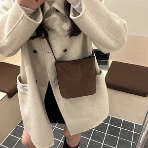 Deep brown suede crossbody square bag with slim strap and minimalist autumn style