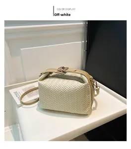 Close-up of beige woven leather pillow bag with metal clasp and thin strap detail