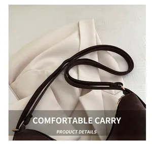 Detail shot of sturdy comfortable handle and metal hardware on coffee brown tote bag