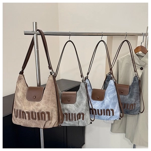 Detail view of vintage-style hobo bags in four colors hanging in a boutique display