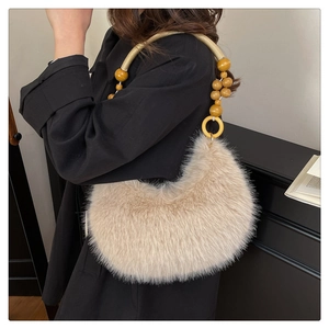 Détail d'un sac à main en fausse fourrure avec perles en bois et anse tressée