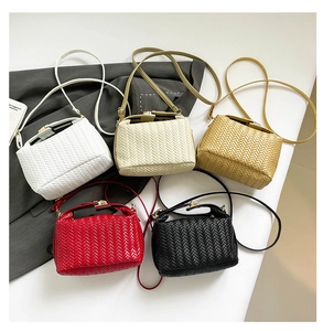 Detail shot of woven texture crossbody bags in white, beige, brown, red, and black colors