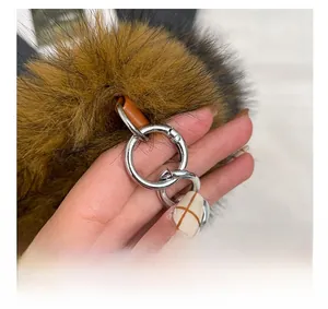 Detail shot of the silver metal clasp and chain on the plush shoulder bag for women