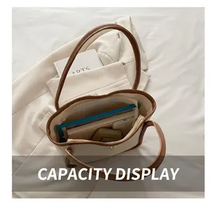 Detail shot of a spacious off-white leather tote bag interior showing ample storage space
