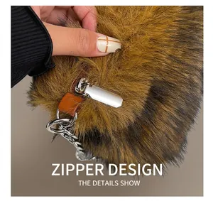 Detailed view of silver metal zipper and chain on brown faux fur shoulder bag