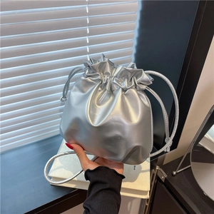 Minimalist silver bucket bag with drawstring closure and metallic faux leather texture