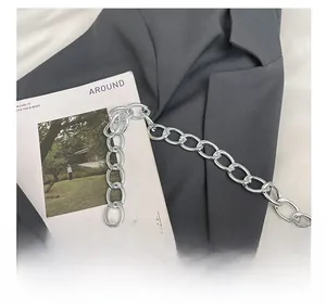 Detail of silver chain strap on a fluffy brown plush shoulder bag with stylish textures