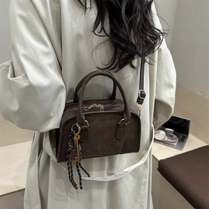 Brown suede crossbody Boston bag with DTN embossing and decorative pendants for women