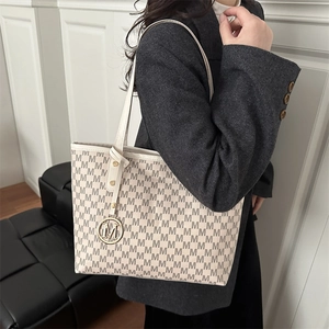 Grand sac cabas beige avec imprimé monogramme M et pendentif métallique élégant