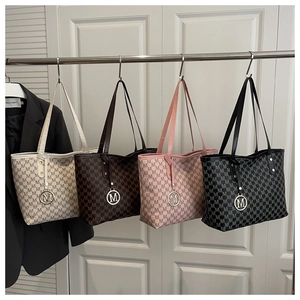 Detail of four retro monogram tote bags in beige, brown, pink, and black with M hardware