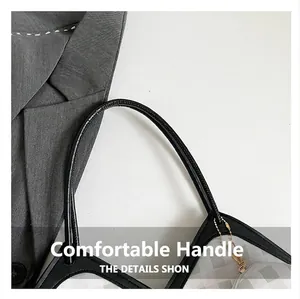 Detail of checkered shoulder bag featuring black handle and golden zipper pendant accents