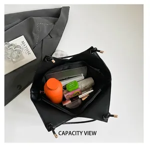 Top view of large black tote bag showing spacious interior with tablet and umbrella