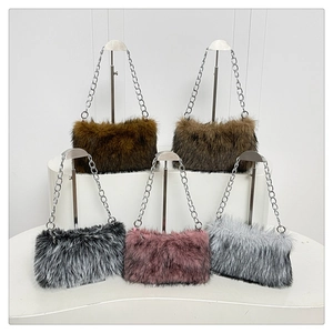 Close-up of five colorful plush shoulder bags with silver metal chain straps for winter
