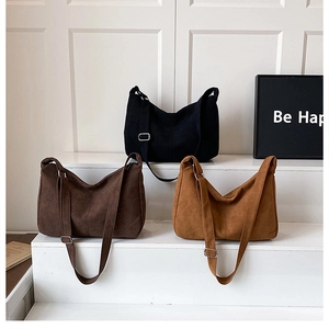 Detailed view of canvas tote bags in black, brown, and beige with adjustable straps