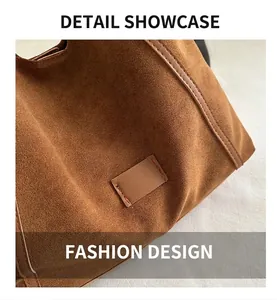 Detail shot of brown matte suede leather tote with decorative stitched rectangular patch