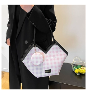 Detail of V-shaped plaid tote bag in pink purple with round coin purse and black handles