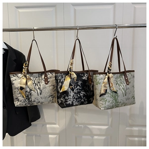 Detailed row of three canvas tote bags with bamboo prints and silk scarf accents