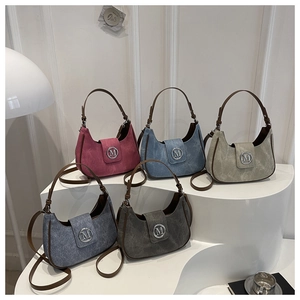 Showcase of minimalist crescent shoulder bags in multiple colors with metallic M hardware