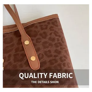 Close-up of leopard print texture with brown leather strap and gold rivet detail