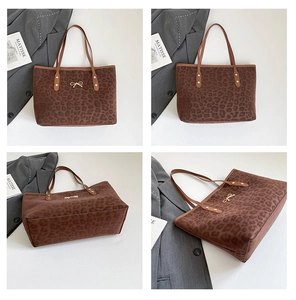 Macro view of leopard print tote bag with golden bow hardware and suede texture