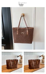 Detail of leopard print tote bag with gold bow clasp and suede texture in coffee brown