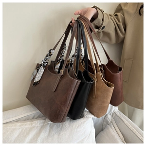 Detail of four retro tote bags in various colors featuring silk scarf handles and topstitching