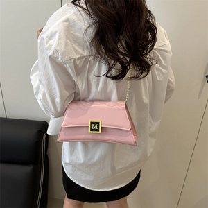 Pink leather shoulder bag with gold M-logo buckle and chain strap shown on model