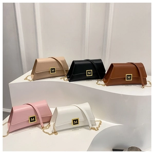 Detail view of stylish small square bags in five colors with gold M metal buckles