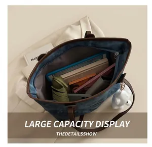 Interior view showing the large capacity of the denim tote bag with daily essentials