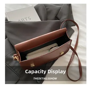 Internal view of the brown crossbody bag showing capacity for a smartphone
