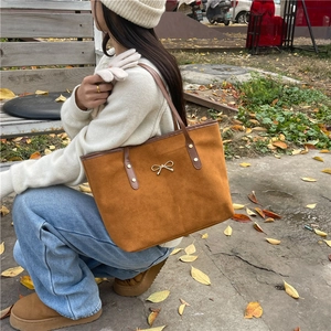 Brown suede tote bag with golden bow accent, minimalist retro style for autumn daily wear