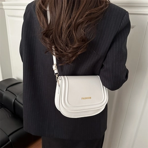 Elegant white leather saddle crossbody bag for women with gold fashion logo and strap