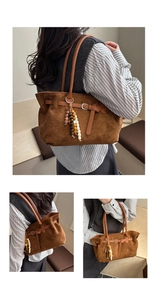 Detail of dark brown suede tote bag featuring leather straps and colorful wooden bead charms