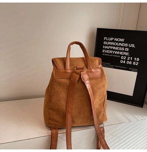 Close-up of brown suede texture on vintage style backpack with leather straps