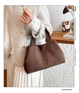 Deep brown suede tote bag styled with a tweed jacket for a minimalist chic autumn look