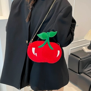 Cute red cherry shaped crossbody bag with green leaf detail and gold metal chain strap