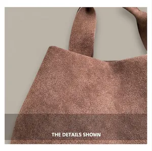 Detail of dark brown matte leather tote bag showing fine texture and clean stitching