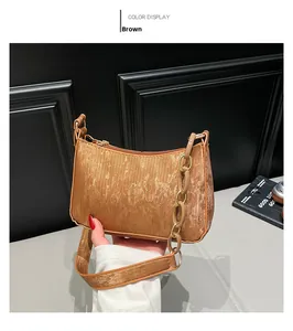 Detailed view of brown textured synthetic leather shoulder bag with matching thick chain strap