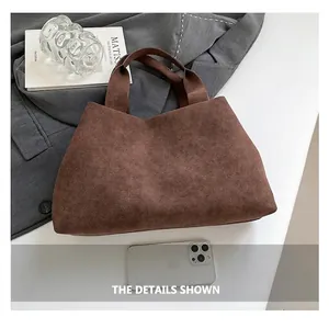 Detail of minimalist dark brown faux suede tote bag on aesthetic background