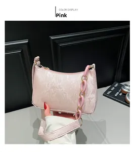 Detail of light pink shoulder bag with thick resin chain strap and metallic texture