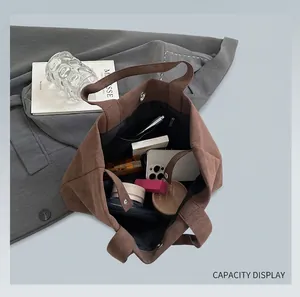 Interior view of brown faux suede tote bag showing large capacity and magnetic closure