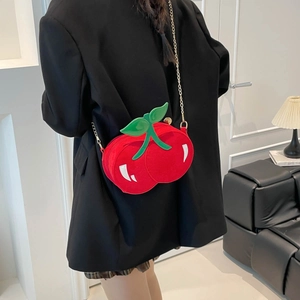 Sweet cherry-shaped crossbody bag with green leaves and gold chain on model