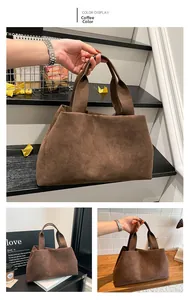 Detail of coffee brown faux suede tote bag featuring a minimalist wide handle and soft texture