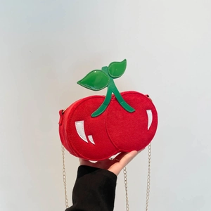 Unique cherry-shaped red crossbody bag with green leaf detail and golden metal chain strap