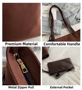 Detail view of dark brown faux suede tote bag with golden hardware and small pouch