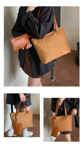 Detail of camel suede tote bag with matching leather zipper pouch and wide shoulder strap