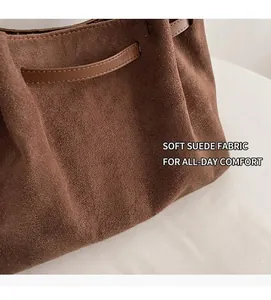 Close-up of deep brown matte suede tote bag with leather straps and retro texture